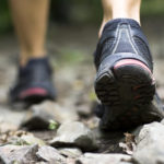 Sport shoes on trail walking in mountains