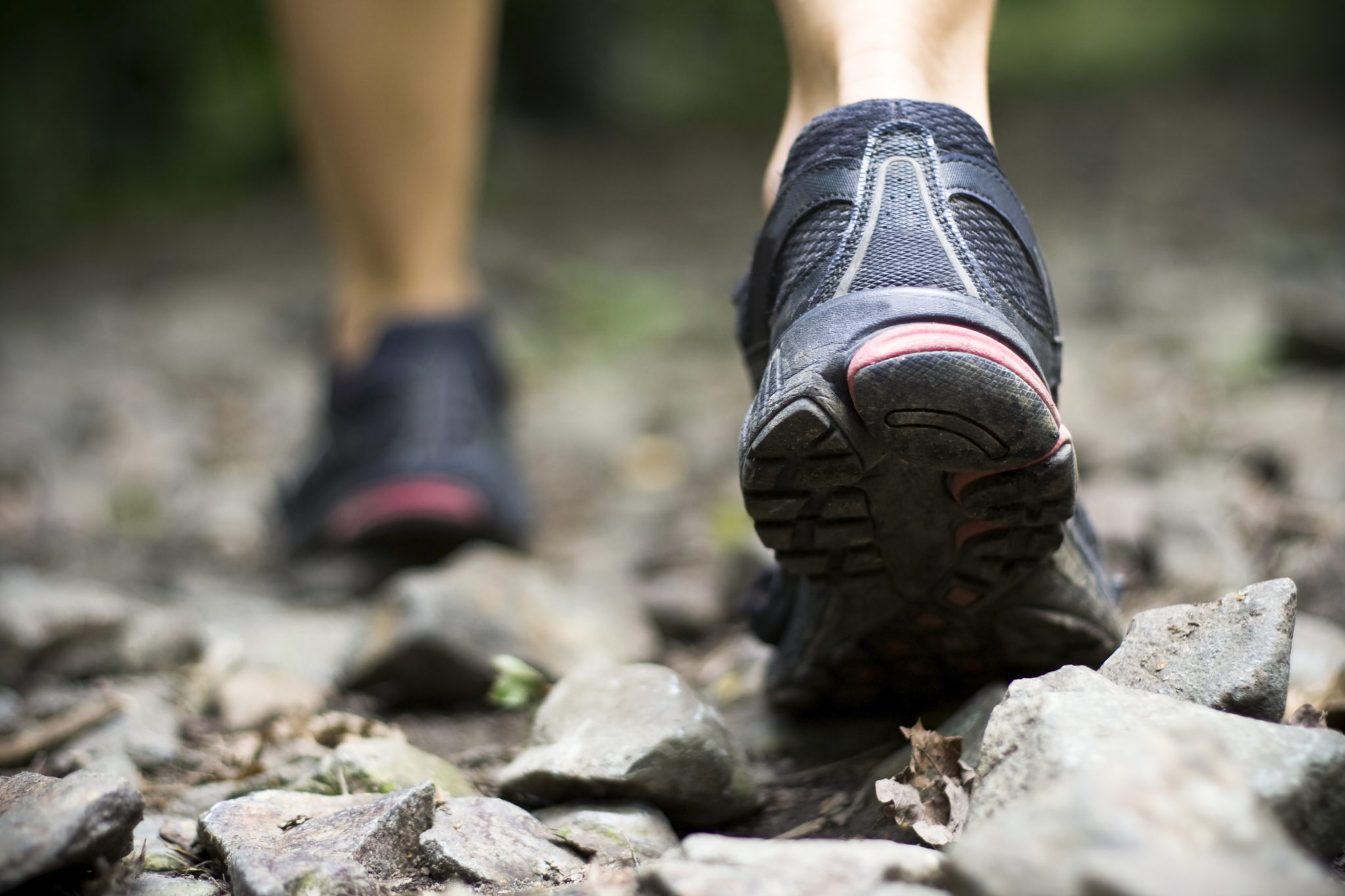 Sport shoes on trail walking in mountains