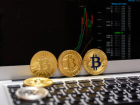 golden bitcoins and chart on monitor