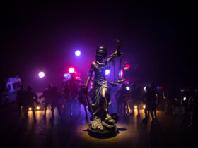 Statue of Justice with anti-riot police helmet holding scale.